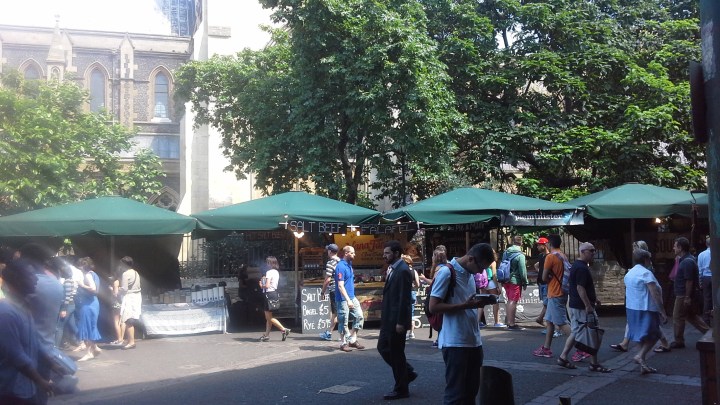 Lunch stalls at Borough market, with Southwark cathedral in the background