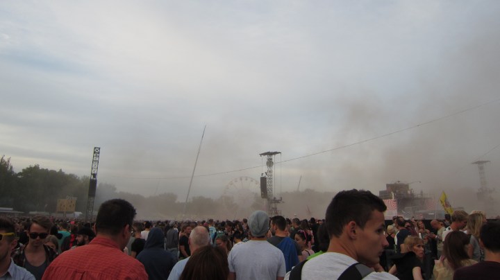 paint dropped, Holi festival style, onto crowds around the main stage