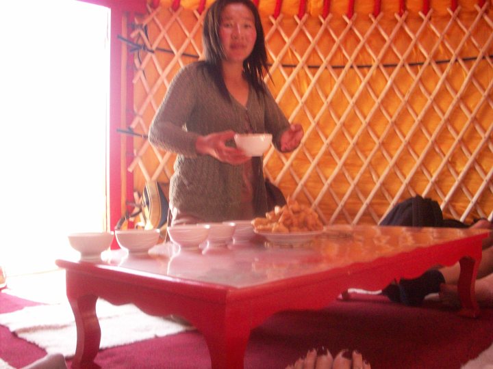 Being served tea in order of seniority.  The oldest gets first and lastly the youngest.  The  woman  guesses and some people weren't happy with their position.