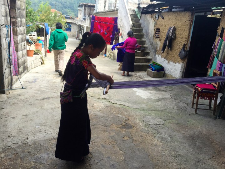 Girl demonstrating traditional weaving methods in Za