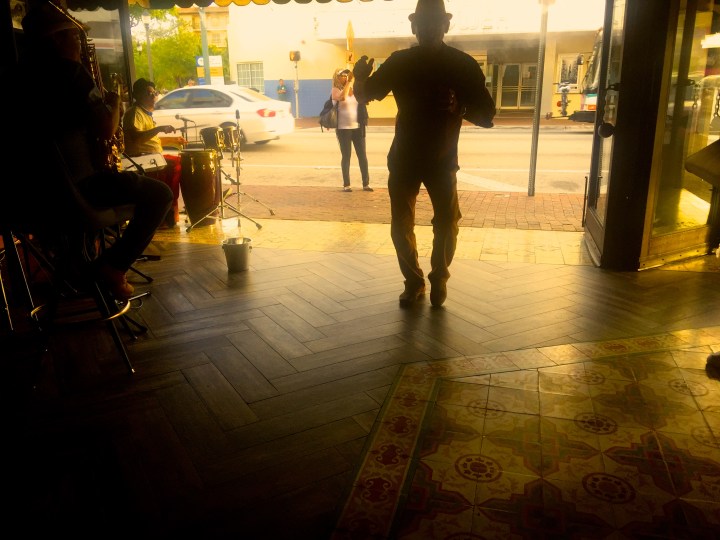 A man dances salsa, alone and completely un self-conscious, at the Ball and Chain